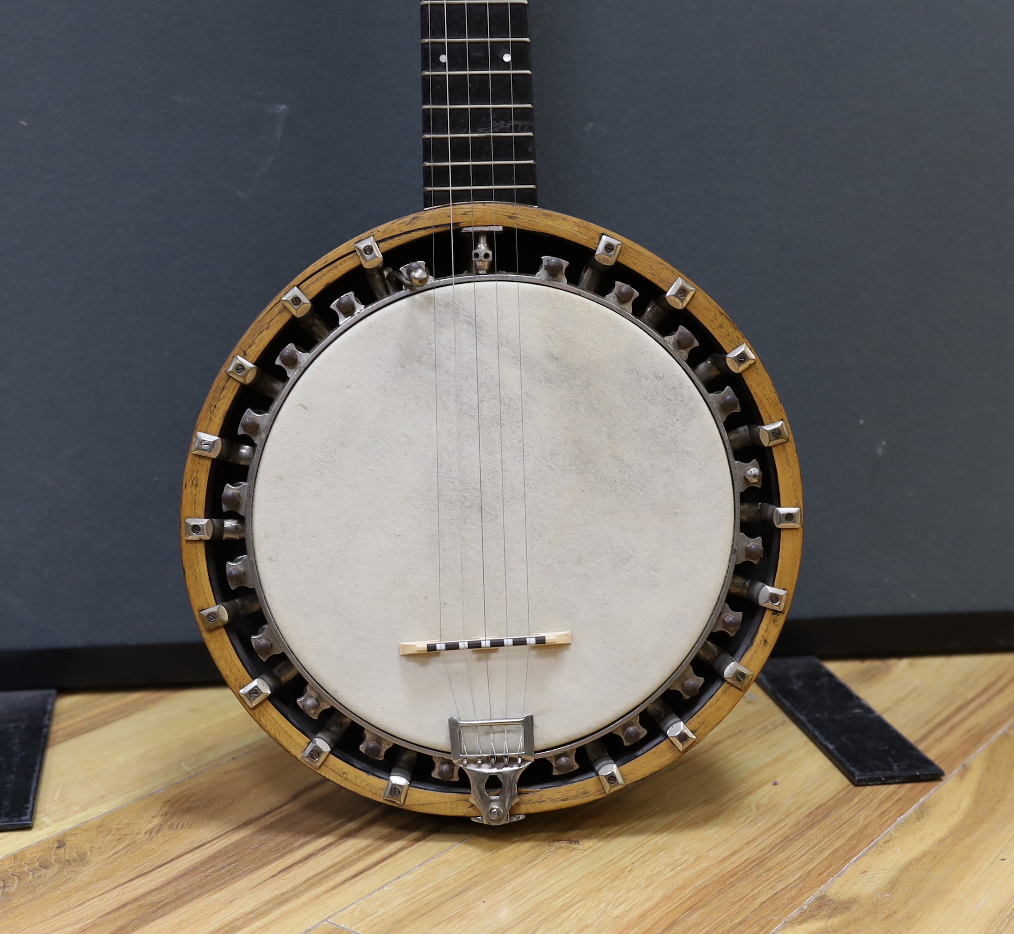 A six string banjo, unmarked, in a hard case by Ashbury